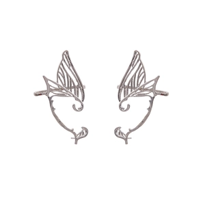 Detailed macro view of silver butterfly wing ear cuffs with hollow elven design