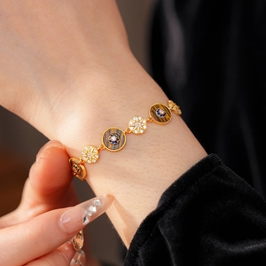 Detailed view of vintage gold bracelet with round tiger eye stone and blue zircon inlay