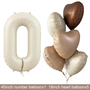Detail of 40-inch cream number zero and 18-inch heart-shaped balloons for birthday party