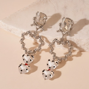 Detailed macro view of silver earrings featuring zircon studs and heart-shaped polka dot beads