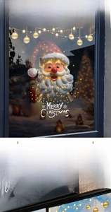 Close-up of Santa Claus Christmas window decals with gold festive ornaments on glass