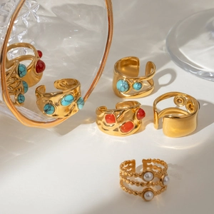 Golden hammer-textured open rings with turquoise, ruby-red stones, and white pearls