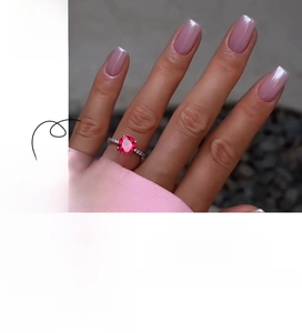Macro detail of nude pink French style press on nails with pearlescent cat eye finish