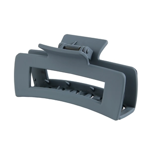Close-up of matte dark grey rectangular hair claw clip with sturdy metal spring mechanism