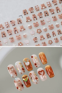 Detail of 3D embossed nail stickers featuring cute cartoon bears and rabbits in caramel tones