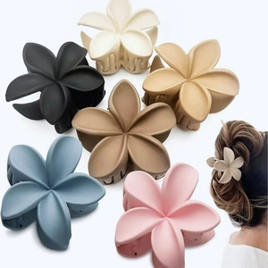 Plumeria flower hair claws in six matte colors shown with a model side view styling