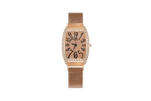 Detail of rose gold tonneau watch with rhinestone bezel and black numerals