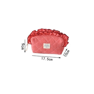Detail of red quilted berry cosmetic bag with ruffle edges and dimensions 17.5x9x10cm