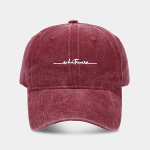 Detail of whatever embroidery on vintage washed cotton burgundy baseball cap