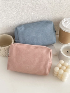 Waterproof PU leather cosmetic bags in blue and pink on a stylish vanity tabletop