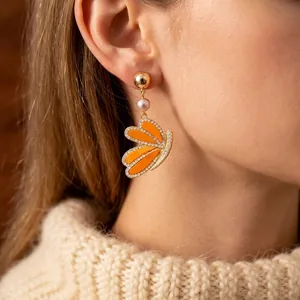 Vintage orange butterfly wing drop earrings with pearls and rhinestones on model
