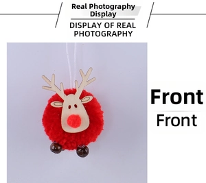 Detail of red pom-pom Christmas reindeer ornament with wooden antlers and a white hanging string
