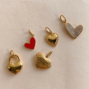 Golden heart pendants collection with enamel, diamonds, and hammered metal textures