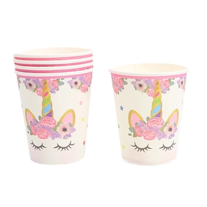 Detail of disposable paper cups with cute unicorn motif and pink flowers for party decor