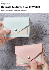 Detail of color-block mini card holder wallet with pebble leather texture and gold keychain