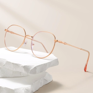 Rose gold square metal glasses frame with anti-blue light lenses on a stone display