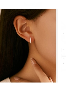 Macro detail of vertical S925 silver stud earrings with five sparkling D color moissanites