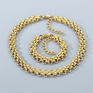 Detailed view of woven golden titanium steel necklace and bracelet set with lobster clasp