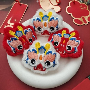 Detail view of plush dragon-themed embroidery accessories with traditional Chinese patterns