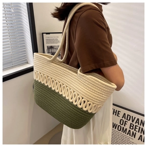 Detail of a beige and olive green woven tote bag in a minimalist Nordic style room