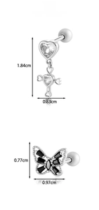 Detailed view of titanium steel heart cross and black butterfly piercing stud earrings