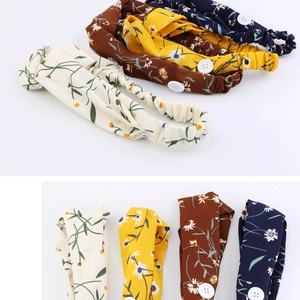 Detailed view of floral chiffon headbands with buttons in four colors and elastic band