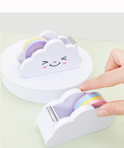 Cloud-shaped tape dispenser with rainbow tape and serrated blade shown by a hand
