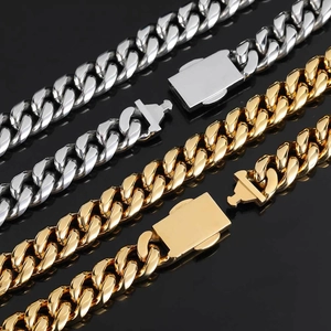Polished silver and gold Cuban link chains with zircon spring buckles on black background