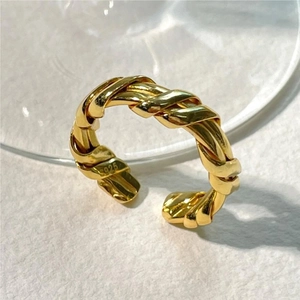 Close-up of S925 hallmark on a golden twisted rope adjustable silver ring band