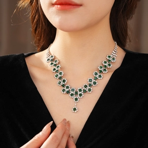 Close-up of elegant emerald sunflower pendant necklace on neck for a luxury stylish look