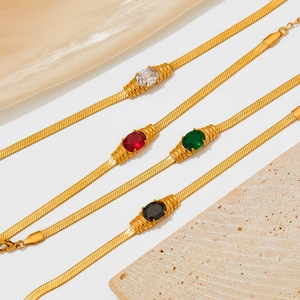 Gold snake chain bracelets with oval gemstone charms in green, red, black and clear
