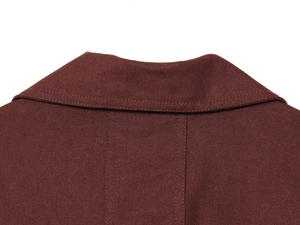 Detail shot of deep brown textured linen shirt collar showing premium stitching quality