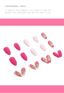 Detail of matte almond press-on nails with floral patterns and pink glitter accents