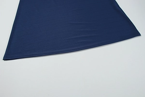 Detailed view of dark blue dress hem featuring premium double-needle stitching quality