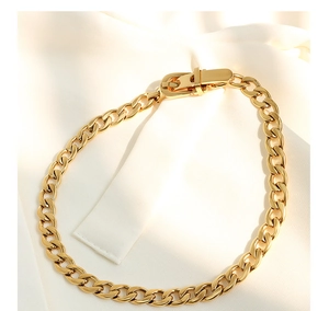 Detailed close-up of chunky gold-plated chain necklace featuring a belt buckle clasp