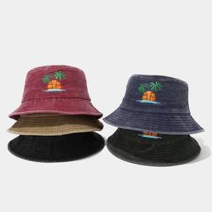 Detailed stack of distressed cotton bucket hats with colorful palm tree embroidery