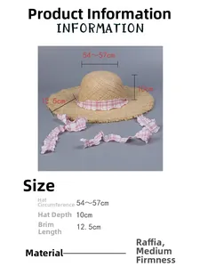 Detail of raffia sun hat featuring pink checkered ribbons and wide brim dimensions