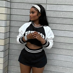Detail of Boston logo print on a cropped black and white sporty baseball sweatshirt
