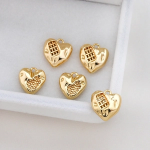 Five gold heart-shaped hollow mesh charms for DIY jewelry making in a white box