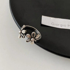 Detailed macro view of vintage hollow double flower open ring with oxidized silver finish