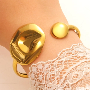 Polished gold organic open cuff bracelet with irregular wave and sphere details