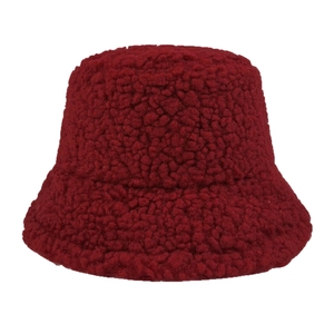 Fashionable dark red lamb velvet bucket hat with thick faux fur texture on white background