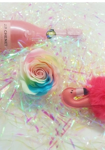 Detail of rainbow rose soap flower and pink flamingo plush toy with iridescent paper filler