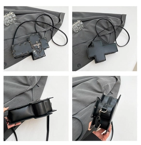 Detail view of black gothic cross bag with silver rivets and metal chain straps