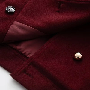 Detail of burgundy wool blend jacket fabric with silk lining and premium buttons