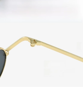 Detailed macro view of sturdy metal hinges and precision screws on retro punk sunglasses