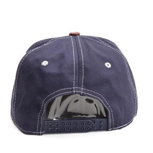Detail of navy snapback cap with white contrast stitching and adjustable back strap