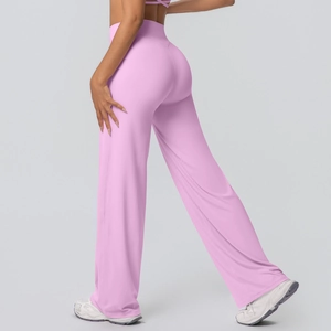 Detail of pink high-waisted yoga flare pants showing elastic fabric and body-shaping fit