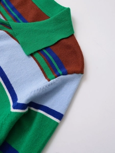 Detail of the green polo collar and colorful striped knit fabric on the shoulder