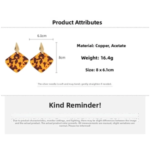 Detail view of geometric rhombus earrings featuring gold copper and tortoise acetate texture